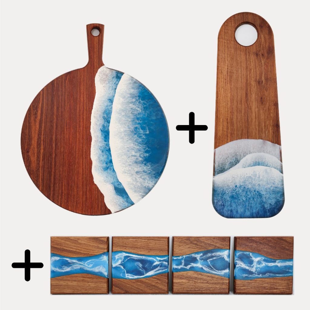 Signature hosting set featuring a round paddle serving board, long bread board, and Tidal ocean resin coaster set styled for entertaining