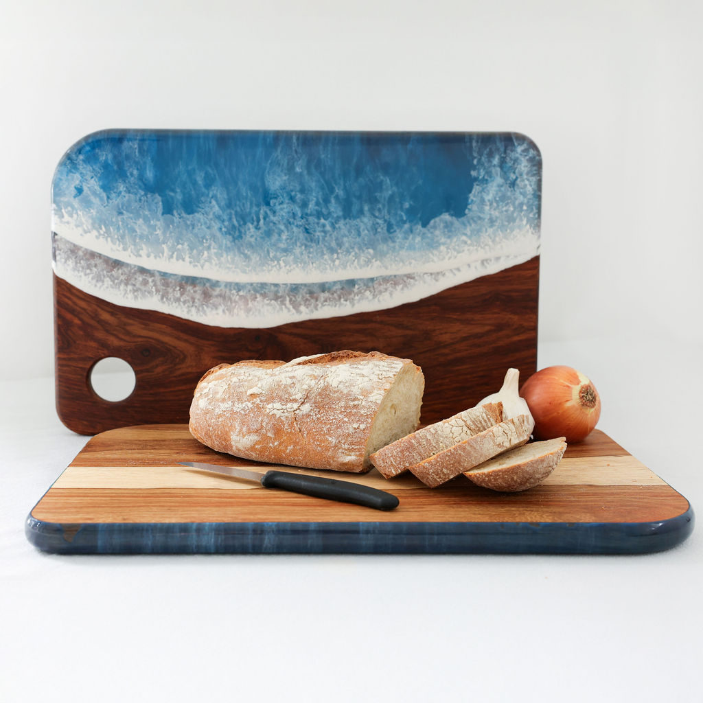 Handcrafted large rectangle serving board showing ocean resin display side and kiaat wood chopping side with loaf of bread