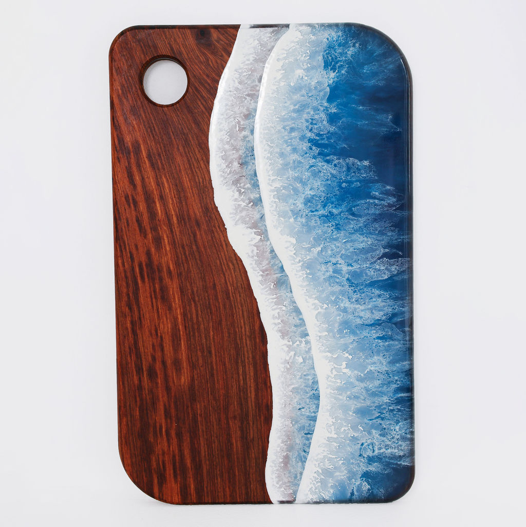 Front view of handcrafted large rectangle kiaat wood serving board with blue ocean resin wave design